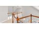 Upper-level landing featuring wood railings, a light-filled space, and access to other areas of the home at 107 Quarter Path, Cary, NC 27518