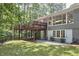Backyard showcasing an elevated deck, gray home exterior, and lush landscaping at 108 Cedar St, Chapel Hill, NC 27514