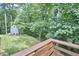 Beautiful grassy back yard and shed seen from wooden deck at 108 Cedar St, Chapel Hill, NC 27514