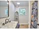 Bathroom with a sleek black faucet, marble countertop and window view at 108 Cedar St, Chapel Hill, NC 27514