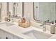 Close up of a double vanity featuring modern fixtures with a woven basket on the countertop at 108 Cedar St, Chapel Hill, NC 27514