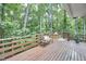 Wide angle view of wooden deck, complete with bench seating, table, stools and potted plant at 108 Cedar St, Chapel Hill, NC 27514