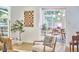 Bright dining area featuring a glass-top table, modern lighting, and a view of nature at 108 Cedar St, Chapel Hill, NC 27514