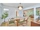 Open dining room with wood floors, modern light fixture, and open view into the living room at 108 Cedar St, Chapel Hill, NC 27514