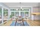 Dining area with modern lighting, a glass table and deck access at 108 Cedar St, Chapel Hill, NC 27514