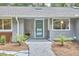 Close up of the front of the home showing the teal front door and newly landscaped yard at 108 Cedar St, Chapel Hill, NC 27514