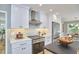 Updated kitchen featuring white cabinetry, stainless steel appliances, and modern finishes at 108 Cedar St, Chapel Hill, NC 27514