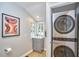Well-lit laundry room with stacked washer and dryer and artwork at 108 Cedar St, Chapel Hill, NC 27514