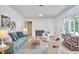 Spacious living room with large windows, wood floors, fireplace and contemporary decor at 108 Cedar St, Chapel Hill, NC 27514
