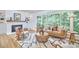 Bright living room featuring a fireplace, large window with wooded view, and hardwood floors at 108 Cedar St, Chapel Hill, NC 27514