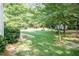 Spacious backyard featuring a lush lawn and mature trees providing ample shade and privacy at 109 Fox Trap Ct, Garner, NC 27529
