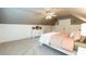 Comfortable bedroom featuring a light ceiling fan, white wainscoting, and painted accent wall at 109 Fox Trap Ct, Garner, NC 27529