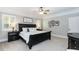 Traditional bedroom featuring a dark wood sleigh bed, ceiling fan, and ample natural light at 109 Fox Trap Ct, Garner, NC 27529