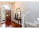 Welcoming entryway with hardwood floors and arched, stained glass front door at 109 Fox Trap Ct, Garner, NC 27529