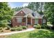 Stunning brick home with mature trees, well-kept landscaping, and classic architectural details at 109 Fox Trap Ct, Garner, NC 27529