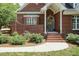 Elegant brick home featuring a charming front entrance with a decorative wreath and manicured landscaping at 109 Fox Trap Ct, Garner, NC 27529