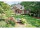 Lovely brick home with a beautifully landscaped front yard, mature trees, and inviting curb appeal at 109 Fox Trap Ct, Garner, NC 27529