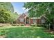 Charming brick home featuring a well-manicured lawn, beautiful landscaping, and inviting front entrance at 109 Fox Trap Ct, Garner, NC 27529