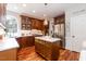 Kitchen with an island, wood floors, stainless refrigerator, white countertops, and a pantry door at 109 Fox Trap Ct, Garner, NC 27529