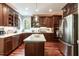 A spacious kitchen features an island, stainless steel appliances, and dark wood cabinets at 109 Fox Trap Ct, Garner, NC 27529