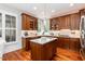 Modern kitchen with custom cabinets, stainless steel appliances, and a center island at 109 Fox Trap Ct, Garner, NC 27529
