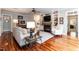 Elegant living room with hardwood floors, built-in shelving, and a fireplace at 109 Fox Trap Ct, Garner, NC 27529