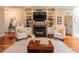 Cozy living room with a fireplace, built-in shelves, and hardwood floors at 109 Fox Trap Ct, Garner, NC 27529