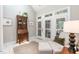 Bright living room with white tile flooring and french doors at 109 Fox Trap Ct, Garner, NC 27529