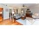 Open-concept living room with hardwood floors, a sofa, and a piano at 109 Fox Trap Ct, Garner, NC 27529