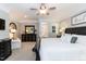Bright primary bedroom featuring a ceiling fan, crown moulding, and ensuite bathroom entrance at 109 Fox Trap Ct, Garner, NC 27529