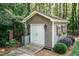 Backyard outbuilding featuring vertical siding, double door, and window boxes at 109 Fox Trap Ct, Garner, NC 27529