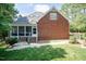 Brick home with screened porch, back patio, steps, and green lawn at 109 Fox Trap Ct, Garner, NC 27529