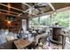 Bright screened porch with brick walls, fan, TV, and comfortable seating overlooking a lush green yard at 109 Fox Trap Ct, Garner, NC 27529