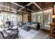 Inviting screened porch featuring brick walls, wood ceilings, and comfortable wicker seating arrangement at 109 Fox Trap Ct, Garner, NC 27529