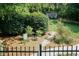 Landscaped backyard featuring flowerbeds, mature trees, garden, and decorative bike at 109 Fox Trap Ct, Garner, NC 27529