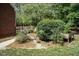 Landscaped backyard featuring flowerbeds, mature trees, and garden at 109 Fox Trap Ct, Garner, NC 27529