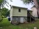 Back exterior of home with basement access, showcasing architectural details and yard at 1106 Fargo St, Durham, NC 27707