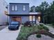 Contemporary home with a blue exterior, modern garage door, and landscaped front yard at 1106 Fargo St, Durham, NC 27707