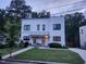 Modern duplex showcasing symmetrical design, manicured lawns, and inviting entrances at 1106 Fargo St, Durham, NC 27707