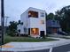 Striking modern home with a white exterior, balcony, and adjacent contemporary blue house at 1106 Fargo St, Durham, NC 27707
