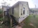 Rear exterior view with stair access, highlighting architectural details and yard space at 1106 Fargo St, Durham, NC 27707
