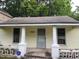 Charming home with a covered front porch, featuring neutral paint and ample natural light at 1106 Fargo St, Durham, NC 27707