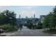 Scenic street view with lush trees and downtown buildings in the distance at 1106 Fargo St, Durham, NC 27707