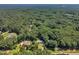 Aerial view showing the home and nearby pool in a neighborhood surrounded by lush, mature trees at 11100 Honeycutt Rd, Raleigh, NC 27614