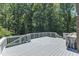 Grey deck with white railing, with lush green trees in the background at 11100 Honeycutt Rd, Raleigh, NC 27614