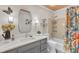 Bright bathroom with marble vanity, colorful shower curtain, and decorative accents at 11100 Honeycutt Rd, Raleigh, NC 27614