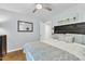 Bedroom with hardwood flooring, ceiling fan, and neutral color scheme at 11100 Honeycutt Rd, Raleigh, NC 27614