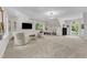 Spacious bonus room features large windows, guitars on the walls, and seating area with television at 11100 Honeycutt Rd, Raleigh, NC 27614