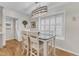 Eat-in dining area with natural light, hardwood flooring, and modern chandelier at 11100 Honeycutt Rd, Raleigh, NC 27614