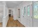 Bright entryway featuring hardwood floors and a decorative glass door with sidelights at 11100 Honeycutt Rd, Raleigh, NC 27614